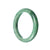 A close-up image of a real Type A Green Jadeite Bangle from MAYS™. The bangle has a 56mm diameter and a semi-round shape.