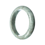 A close-up view of a grey jade bangle, showcasing its smooth, polished surface and half-moon shape.