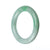 A round, untreated green traditional jade bangle bracelet measuring 58mm in diameter. Made by MAYS.
