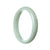 A pale green jadeite jade bangle bracelet with a half moon design, made from genuine natural jade.