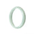 A beautiful, half moon-shaped Burmese Jade bangle in a natural pale green color, measuring 57mm in diameter. Crafted with genuine jade, this bangle from MAYS is a stunning and timeless accessory.