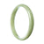 A half moon-shaped green jadeite bracelet with an authentic and natural appeal.